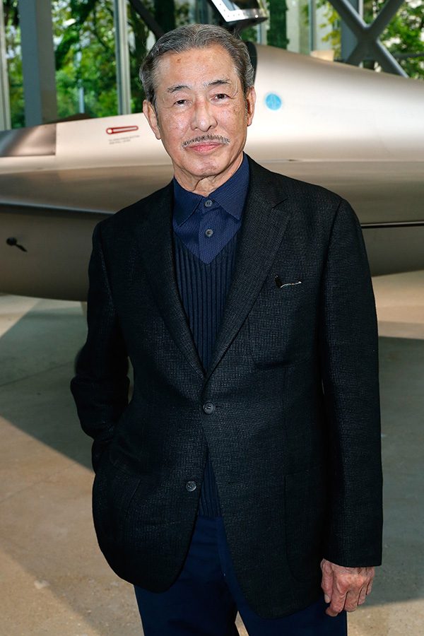 Japanese fashion designer Issey Miyake posing for a photograph